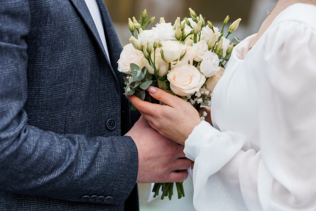 Couple holding bouquet at wedding